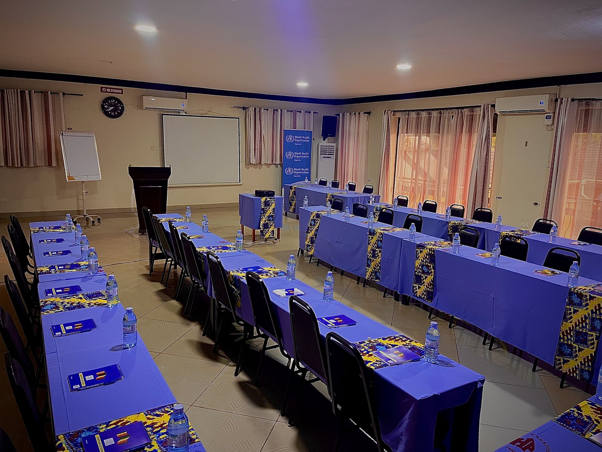 Conference room set up classroom style with projector and flip chart