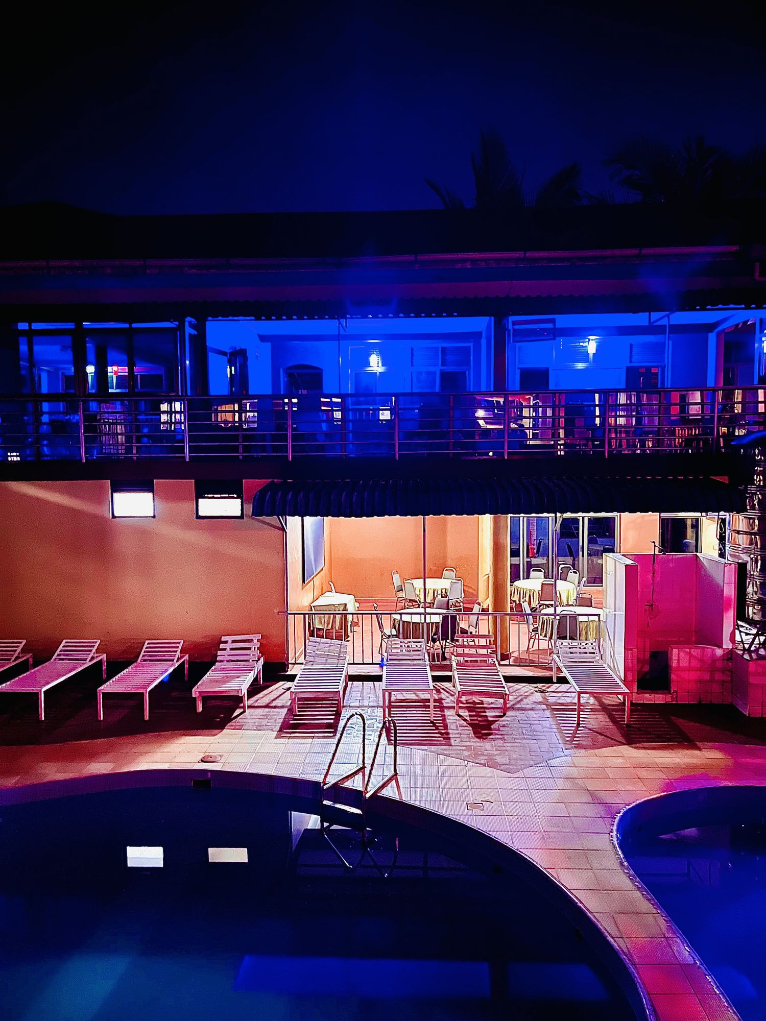 The hotel swimming pool and sun loungers in the evening